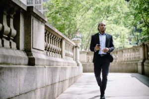 A man in a business suit takes a walk in the park